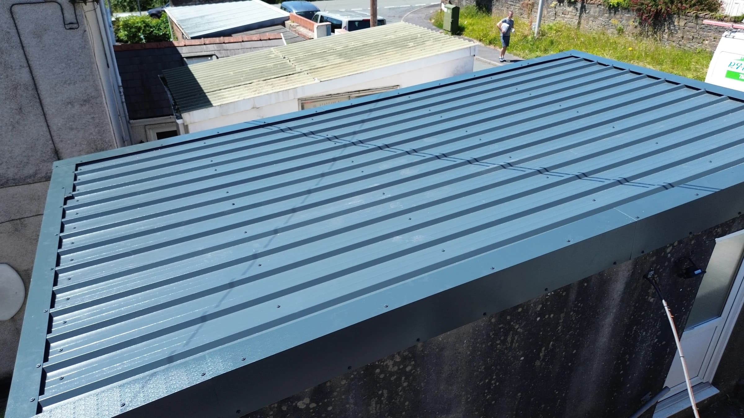 New box profile metal roof installation in progress, Neath