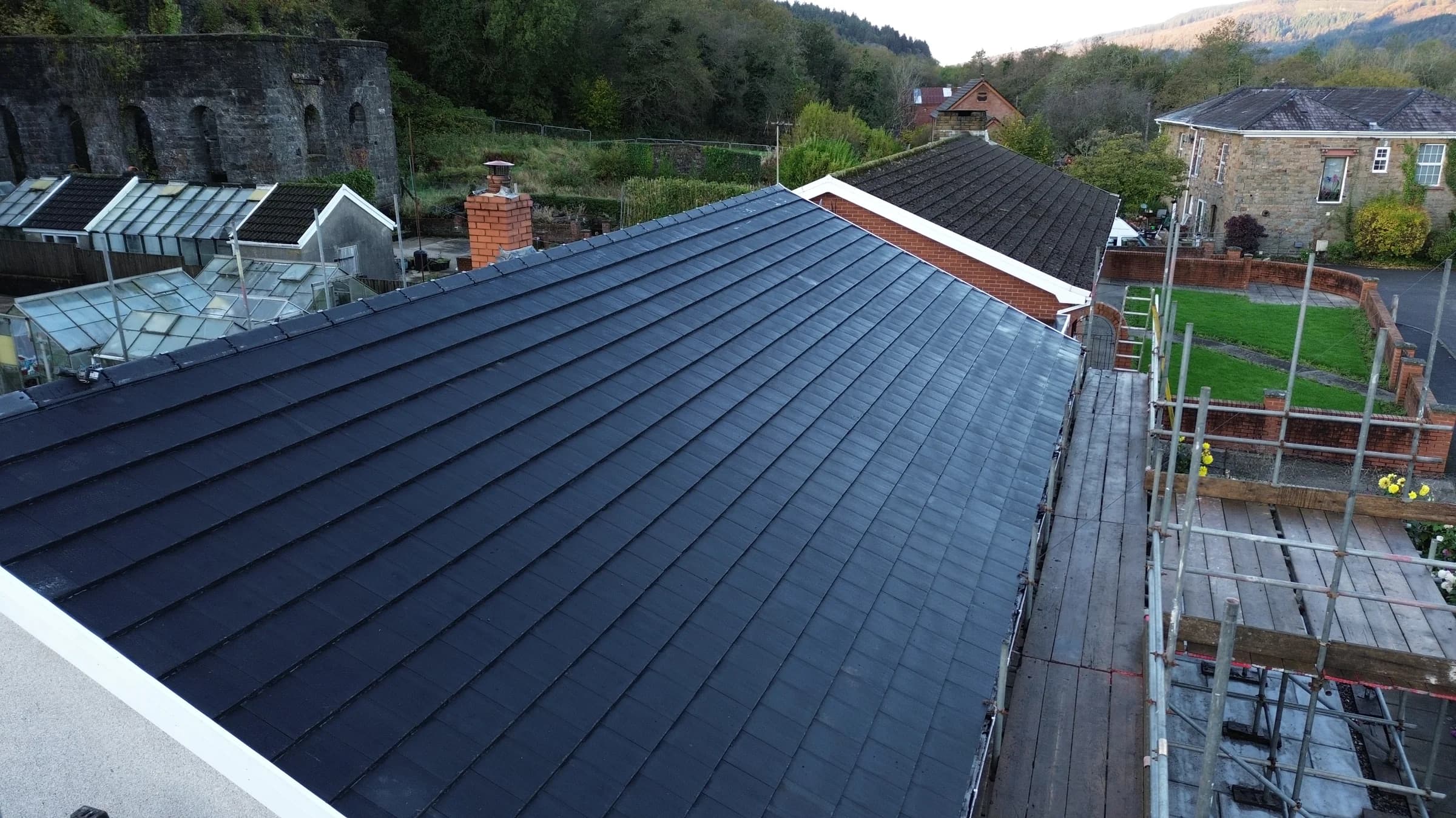 Close up of new grey roof tiles on a pitched roof in Neath